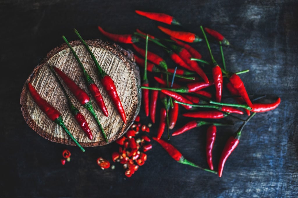 Thai bird's eye chilies on a cutting board.