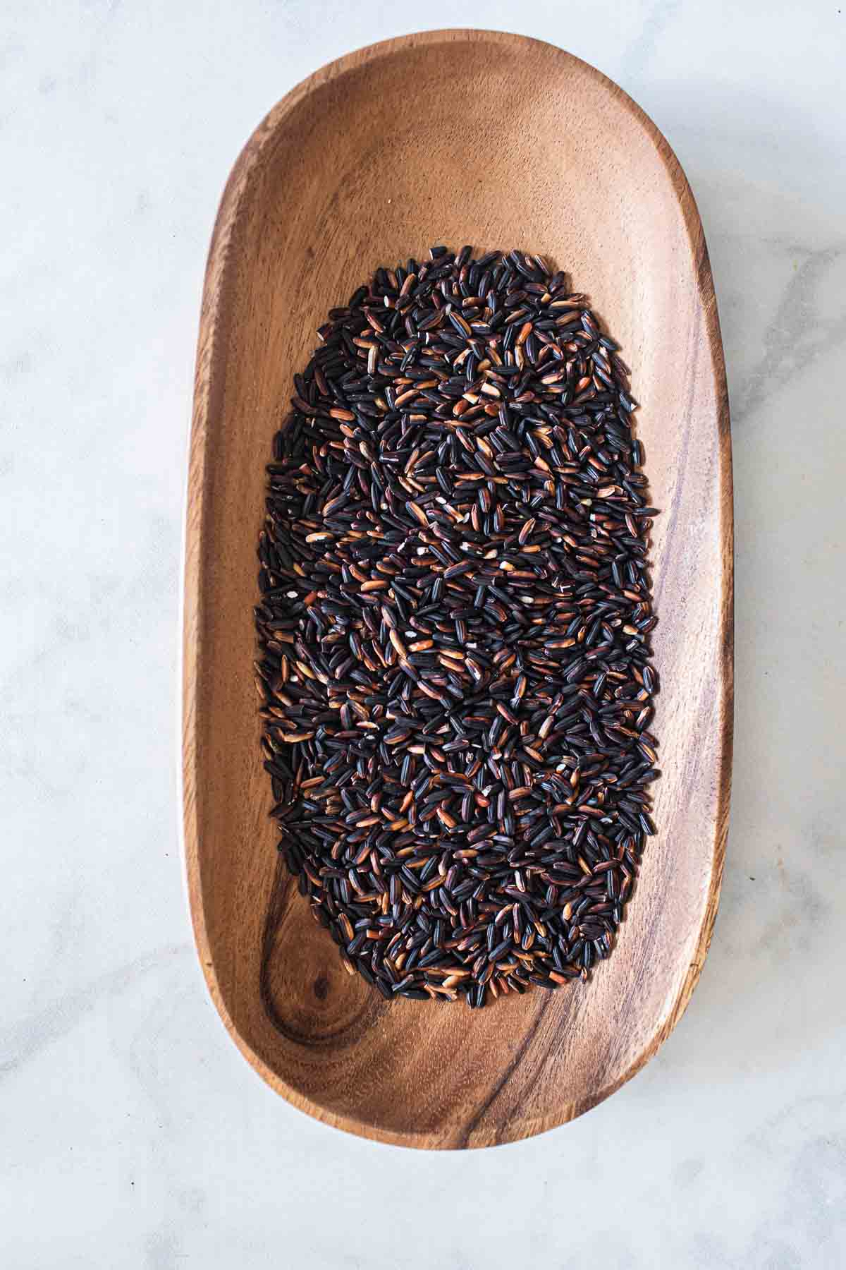 Black rice in a wooden bowl. 