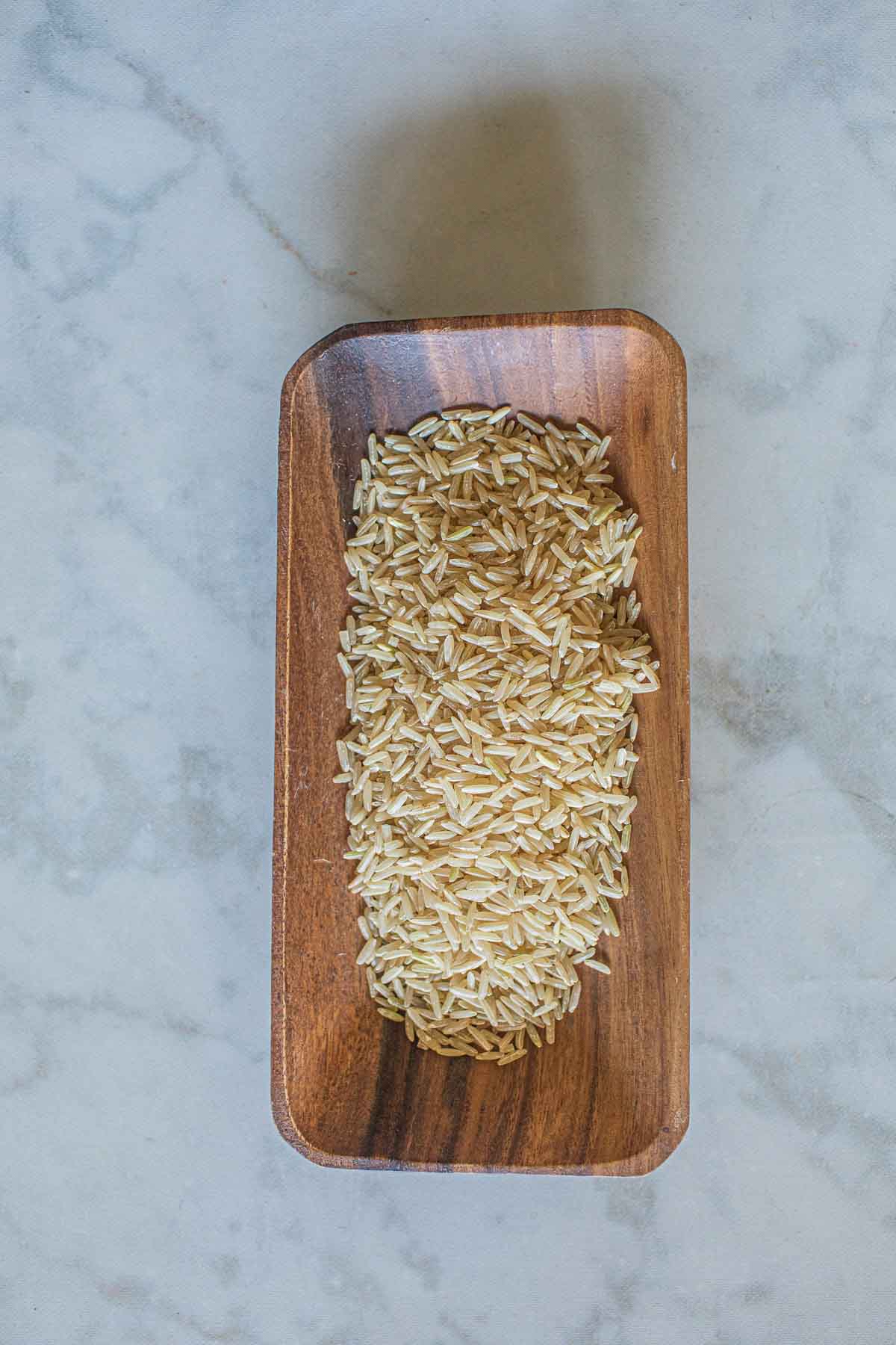 Brown jasmine rice in a wooden bowl.