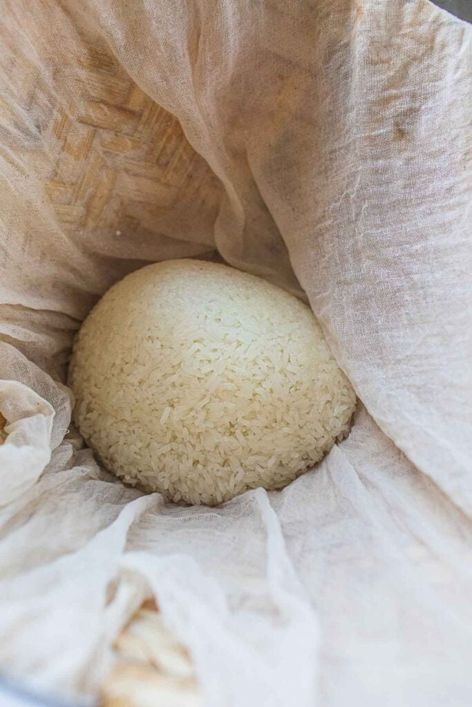 sticky rice in cheesecloth in a basket.