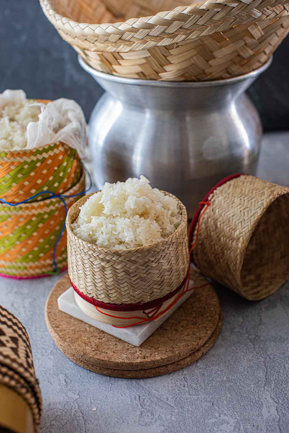 Sticky rice steaming in bamboo baskets over a taoloh at the