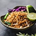 pad mee noodles in a bowl with lime garnish