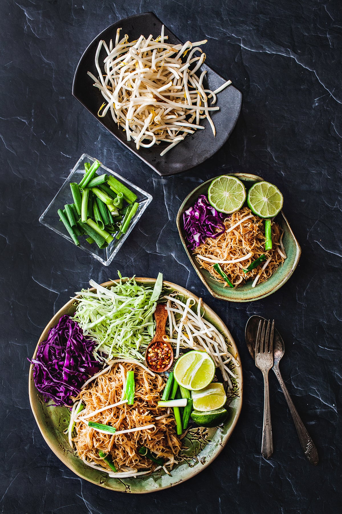 Pad Mee Noodles on platters with garnishes.