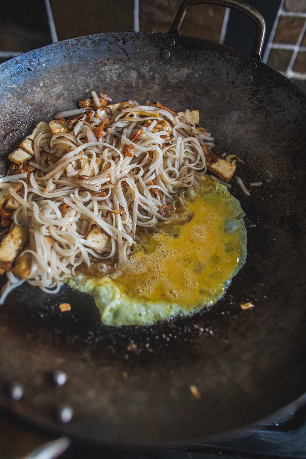 Pad thai noodles with scrambled eggs in a wok
