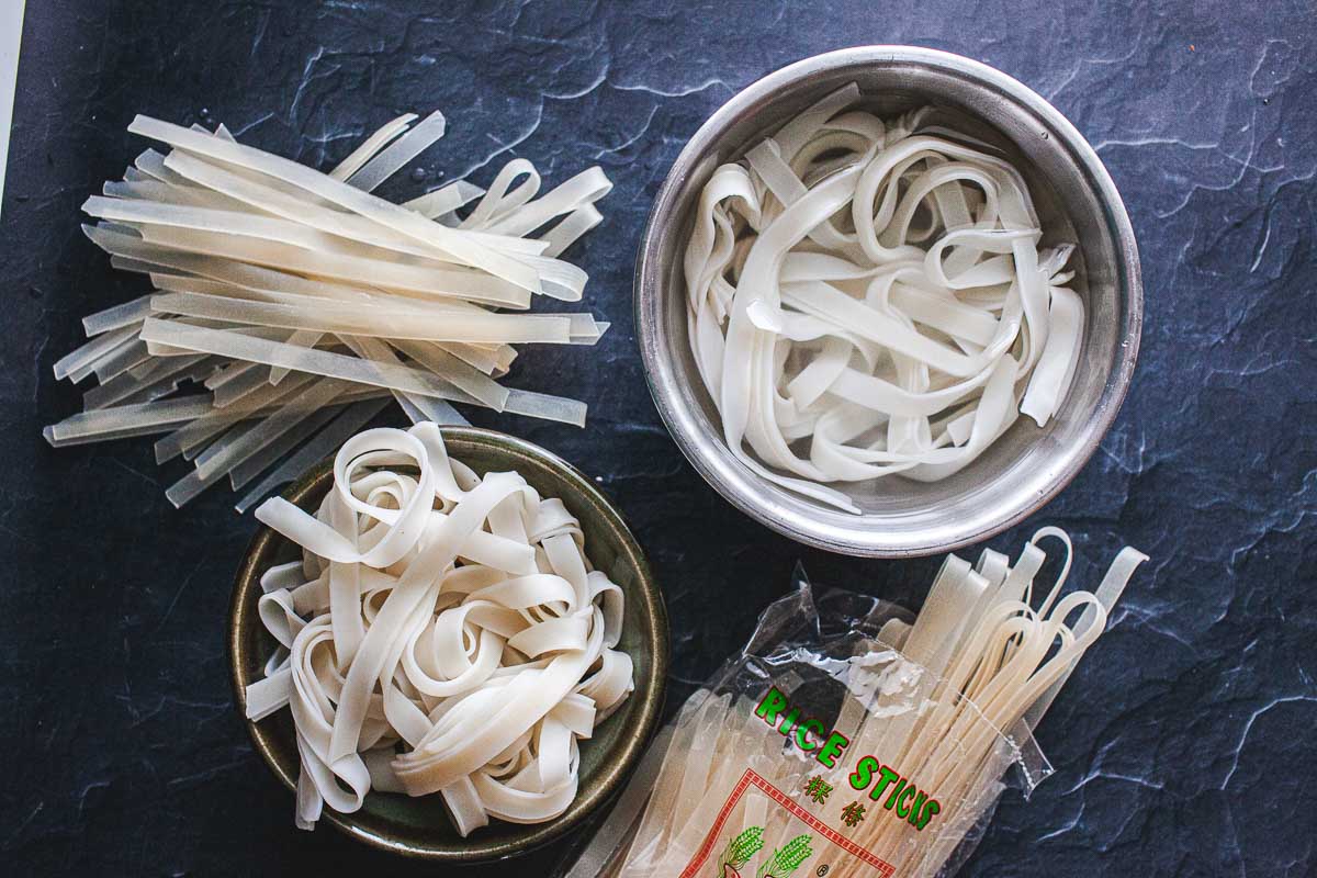 Flat wide rice sticks on a black table