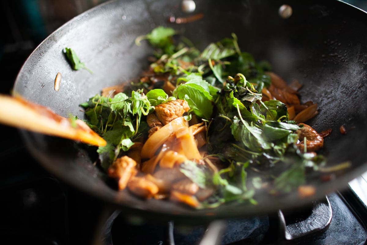 Easy Thai pad kee mao with thai holy basil in a wok. 