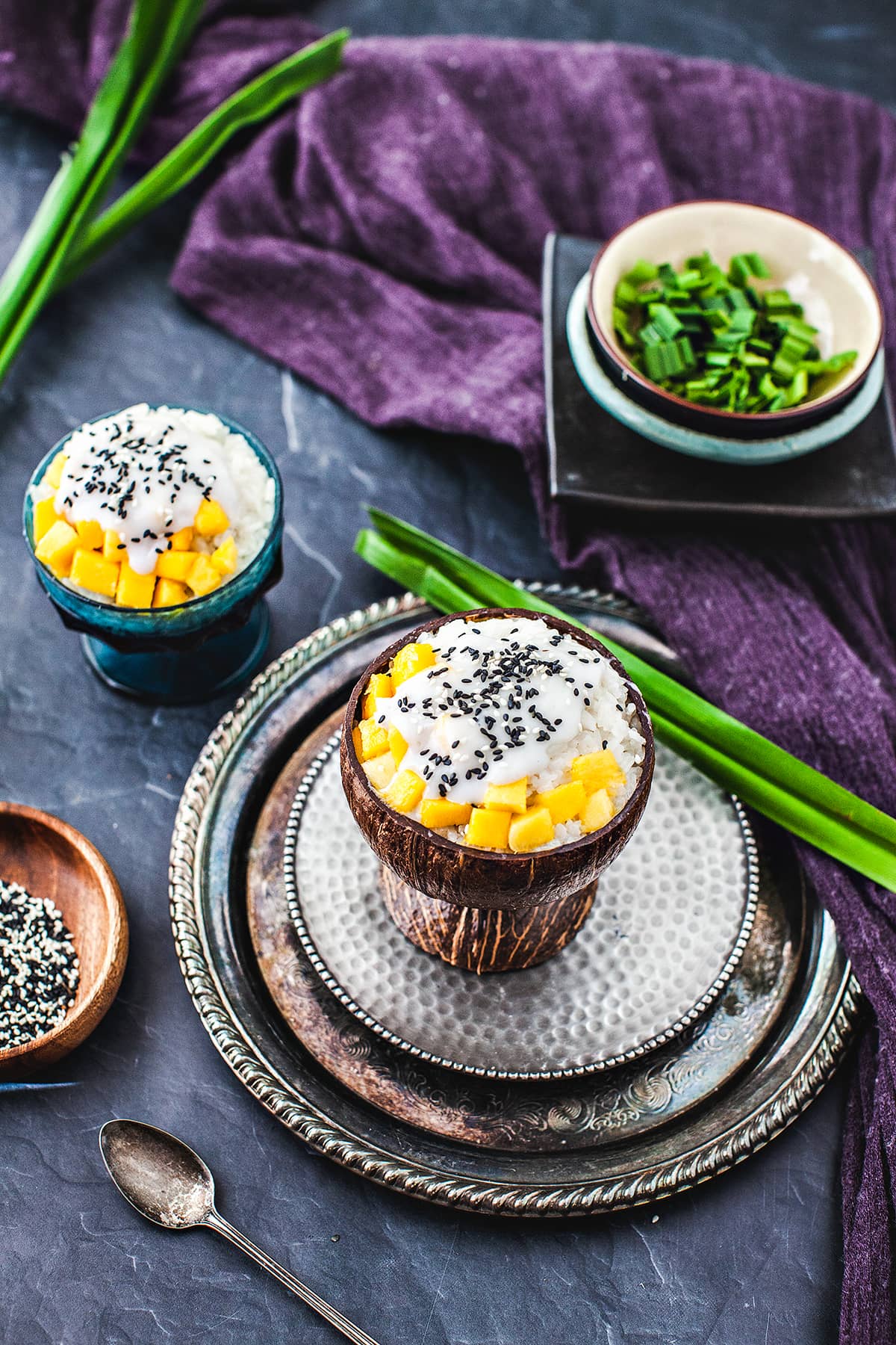 Thai mango sticky rice in a coconut bowl on the table. 