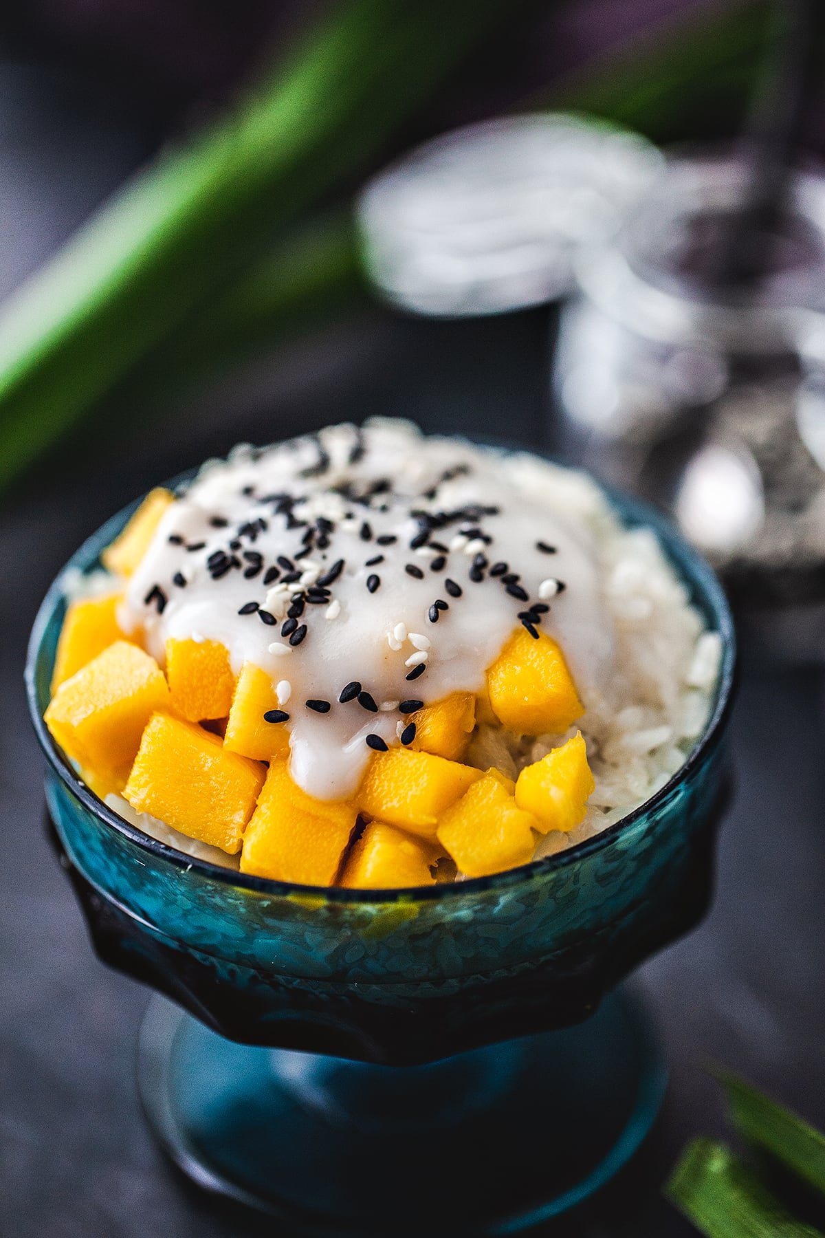 Mango sticky rice with coconut cream and sesame seeds on top.