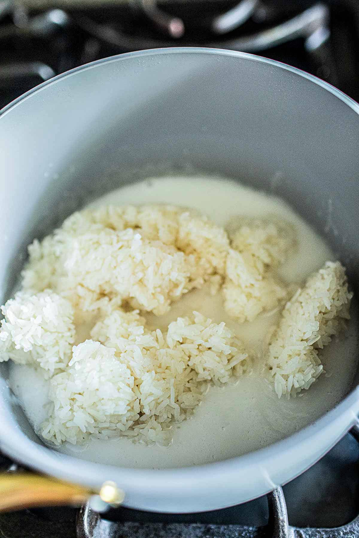 Thai Sticky rice in a pan with coconut cream sauce. 