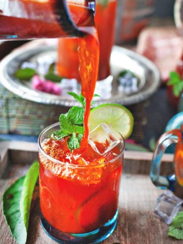 Thai Cha Ma Nao pouring into a glass with ice.