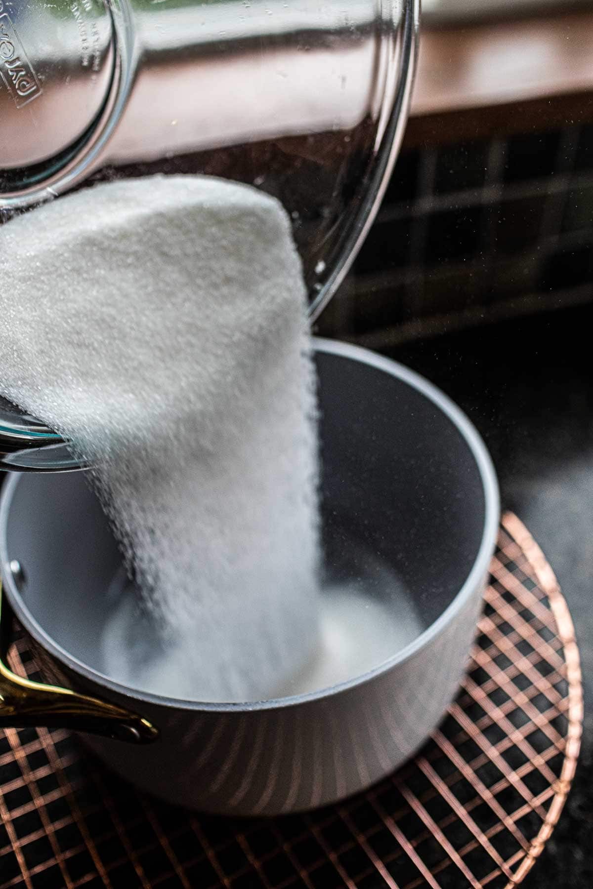 Sugar pouring into a pot.