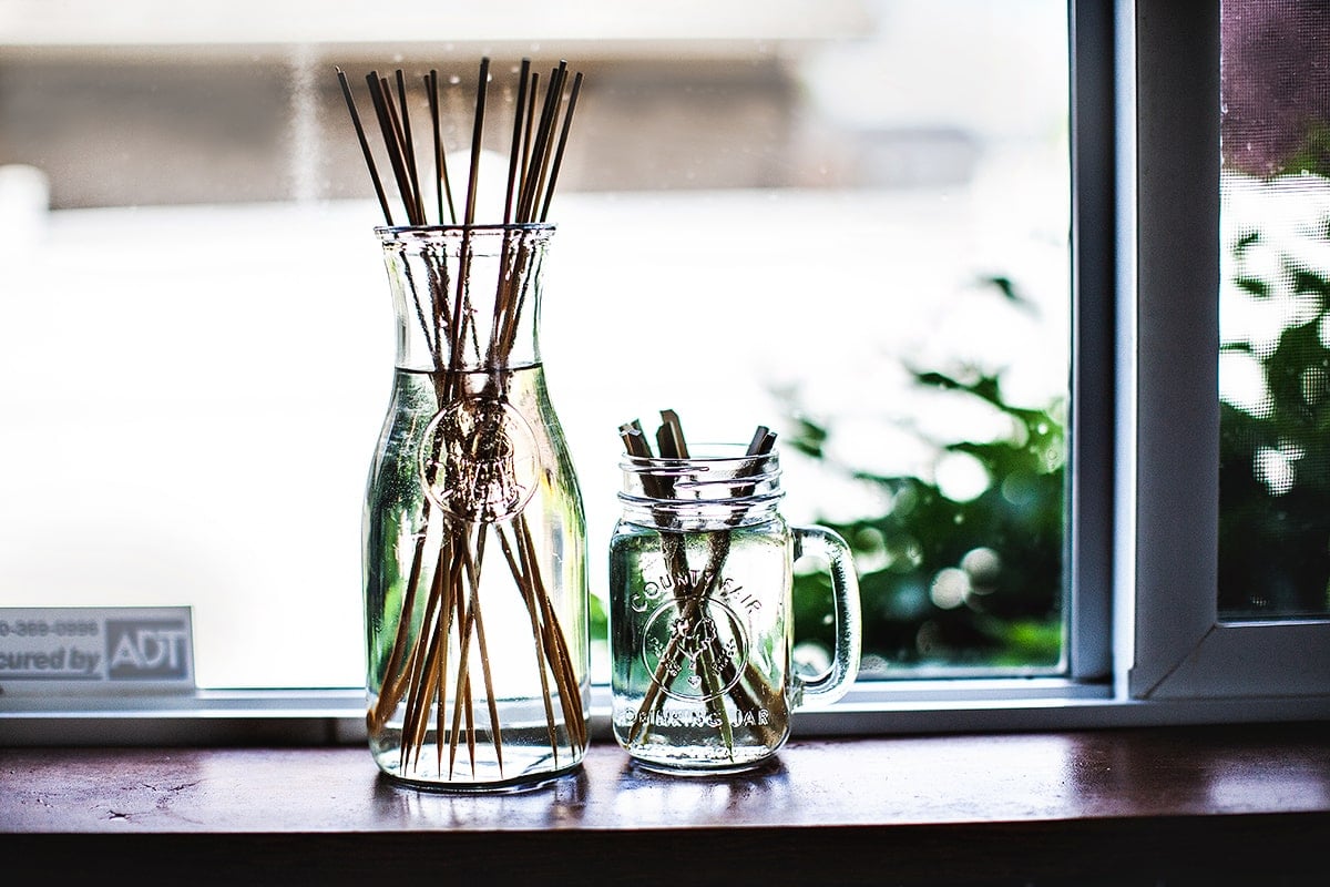 Bamboo pork skewers soaking in a vase. 