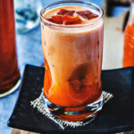 Thai iced tea in a tall glass.