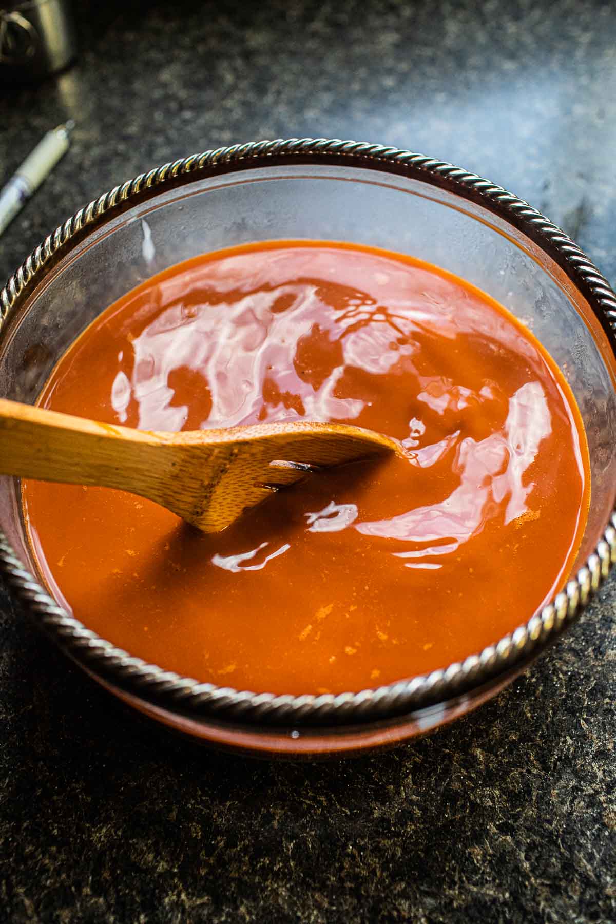 Thai tea in a bowl with wooden spoon.