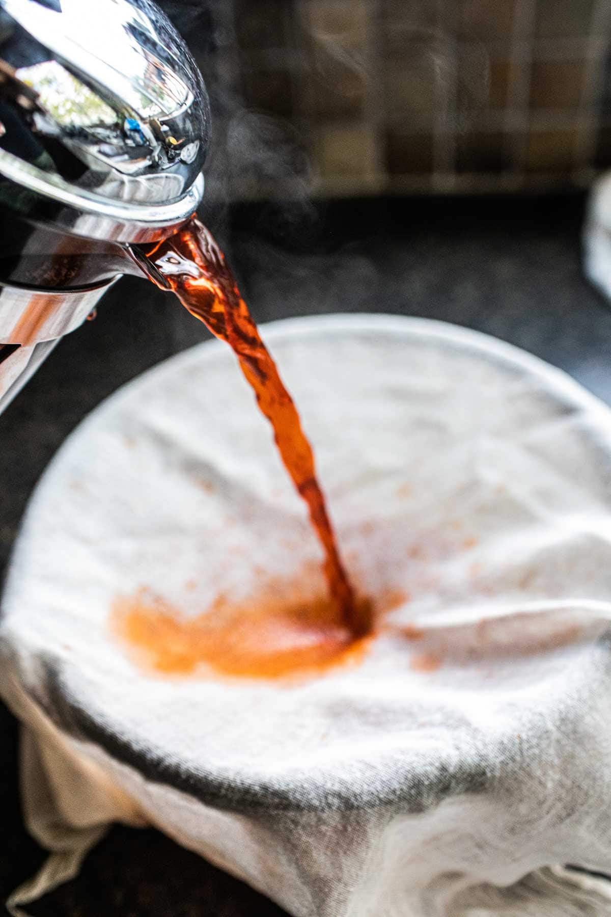 Thai tea pouring into a pot.