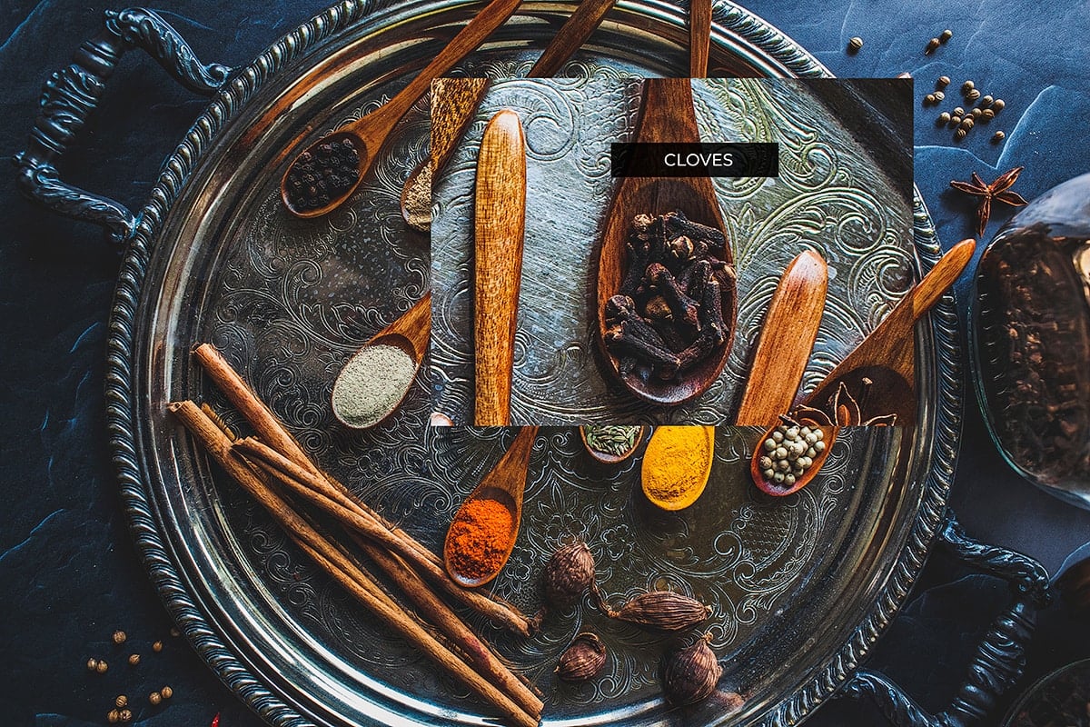 Whole cloves on a stray with other spices.