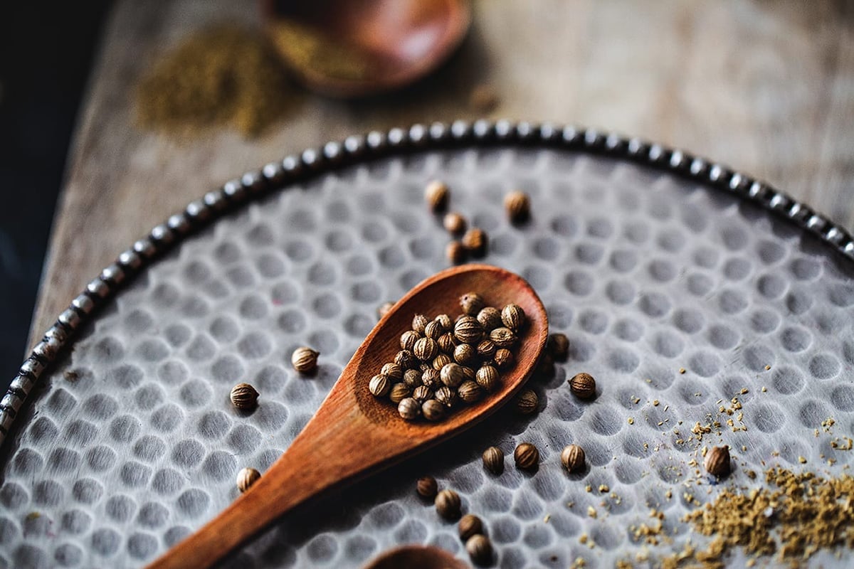 Coriander seeds in a spoon.