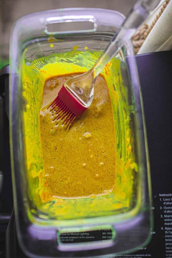 Thai chicken satay marinating sauce in a glass container for grilling gai satay.