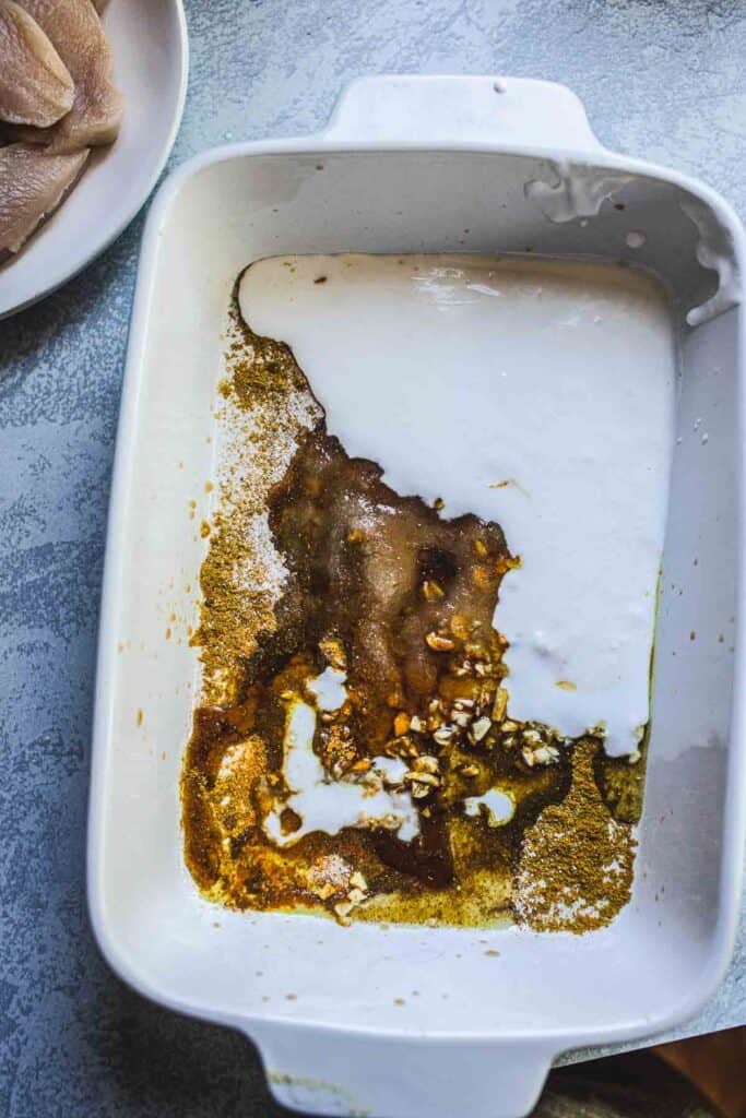Thai satay marinating sauce with spices in coconut milk and seagoing, mixed in a pan.