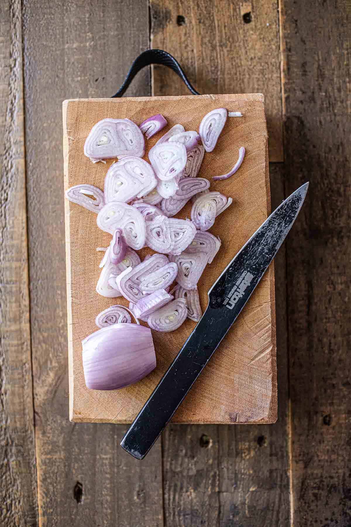 Sliced shallot on a cutting board. 