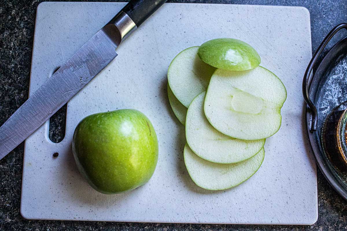 Sliced green apple on a cutting board. 