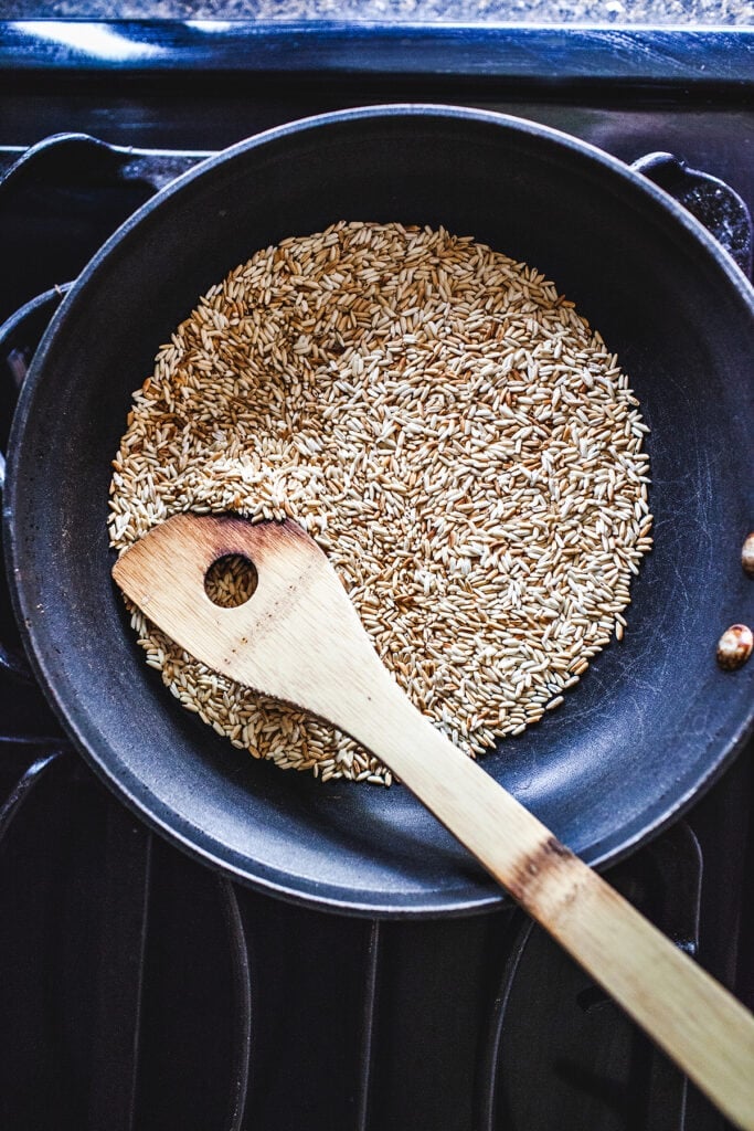 Toasted rice Khao Khua on a skillet on the stove.