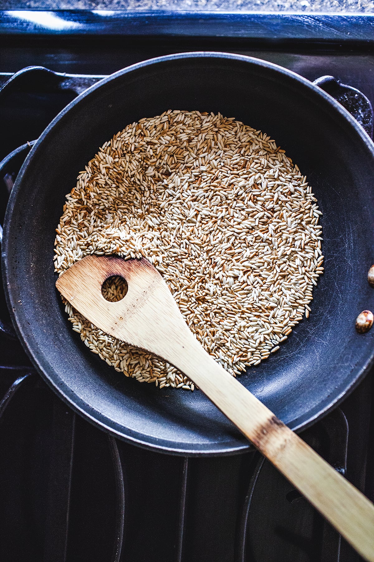 Toasted rice Khao Khua on a skillet on the stove. 