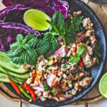 Thai larb Gai with fresh herbs on a plate.