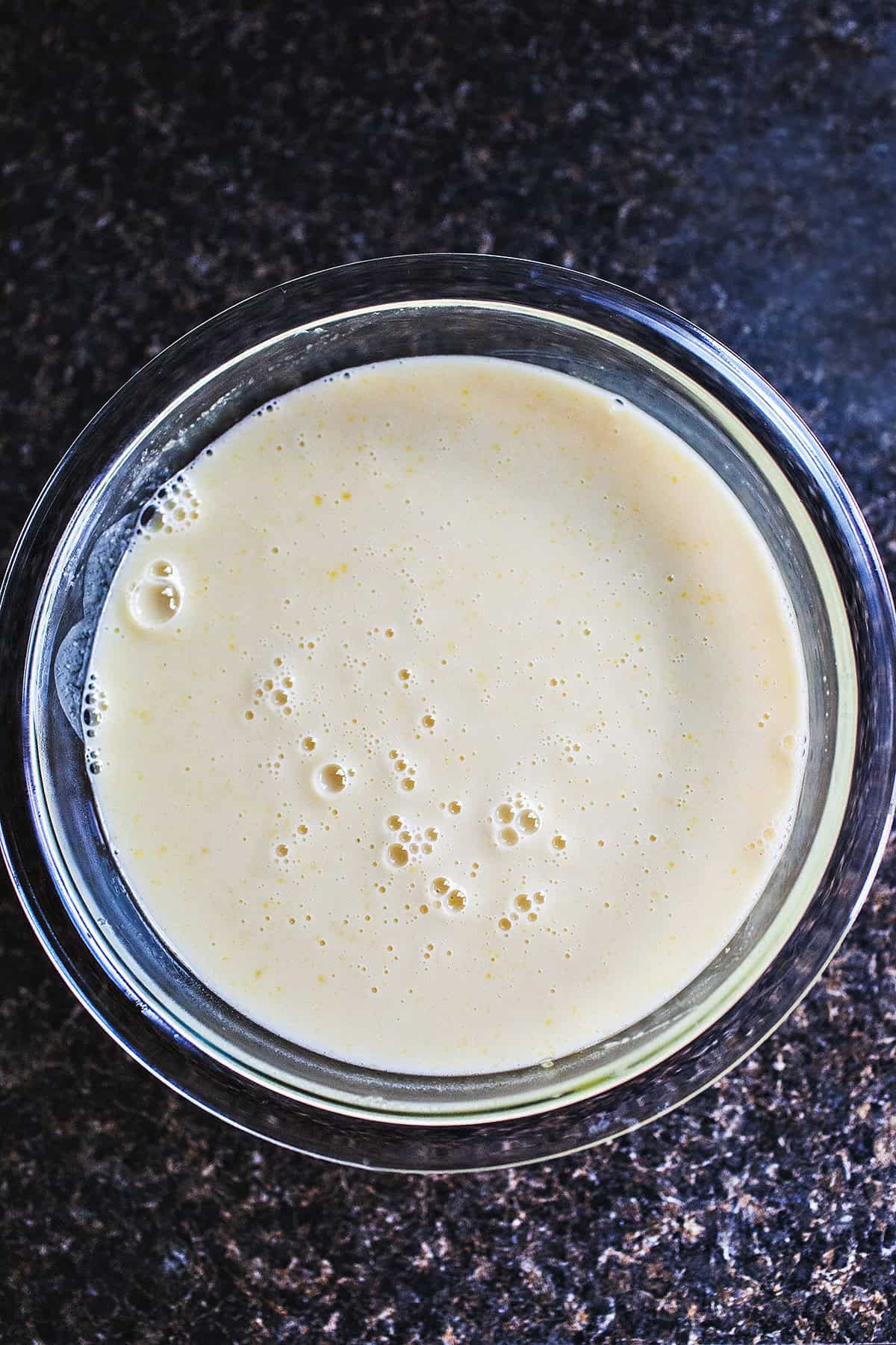 Coconut gelato mixture in a glass bowl. 