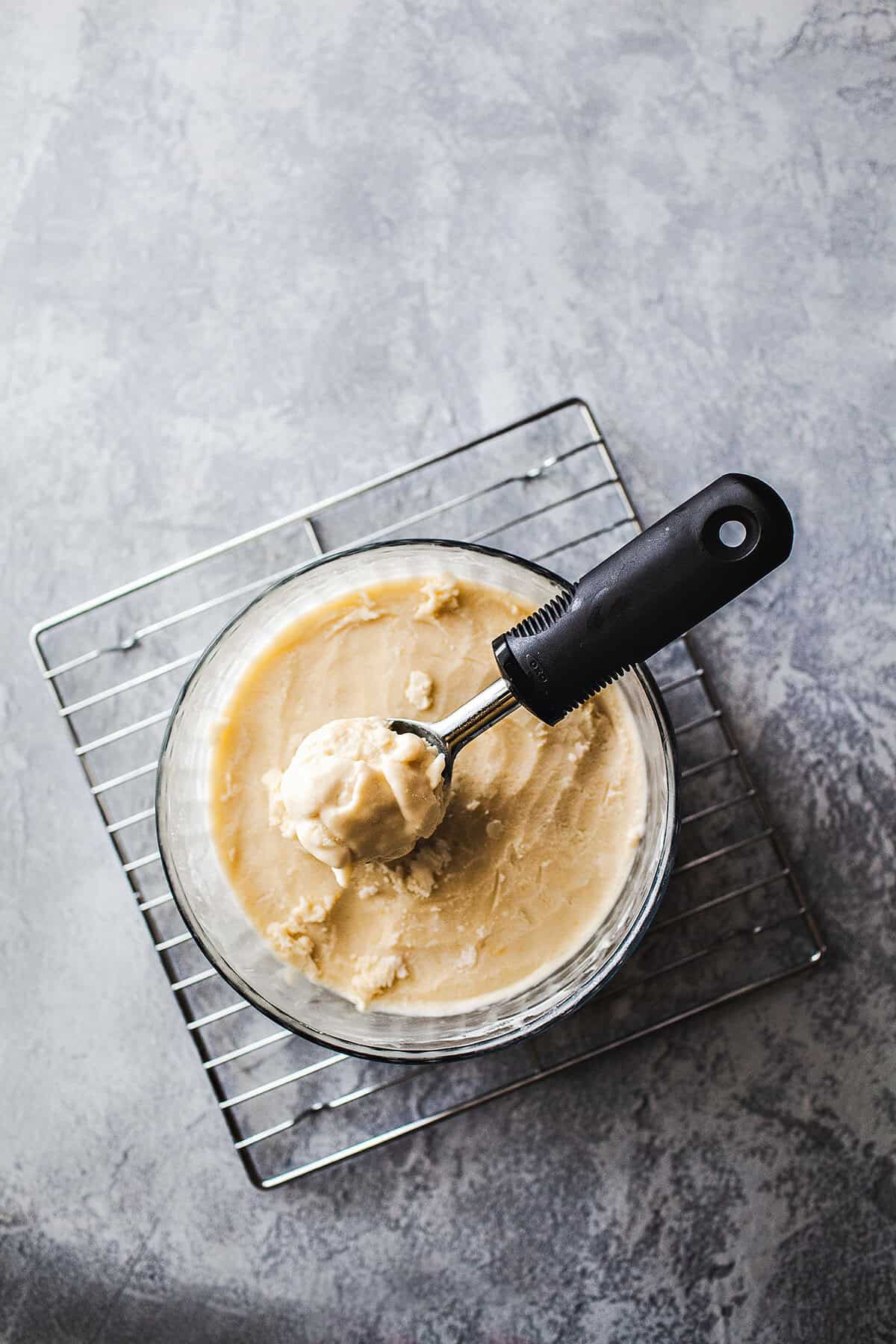 Coconut ice cream in a glass bowl on the table. 