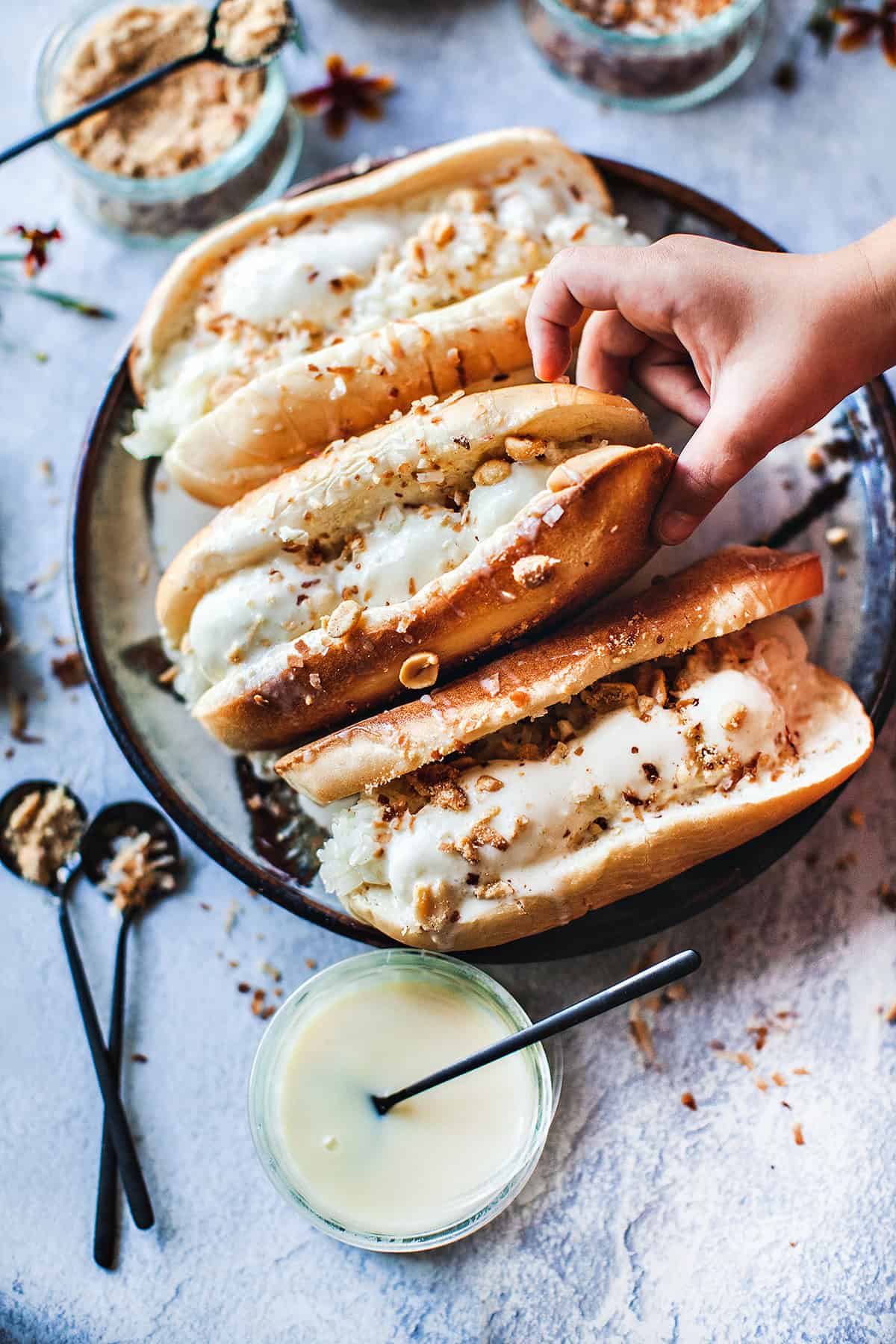 Hand grabbing Thai coconut ice cream.