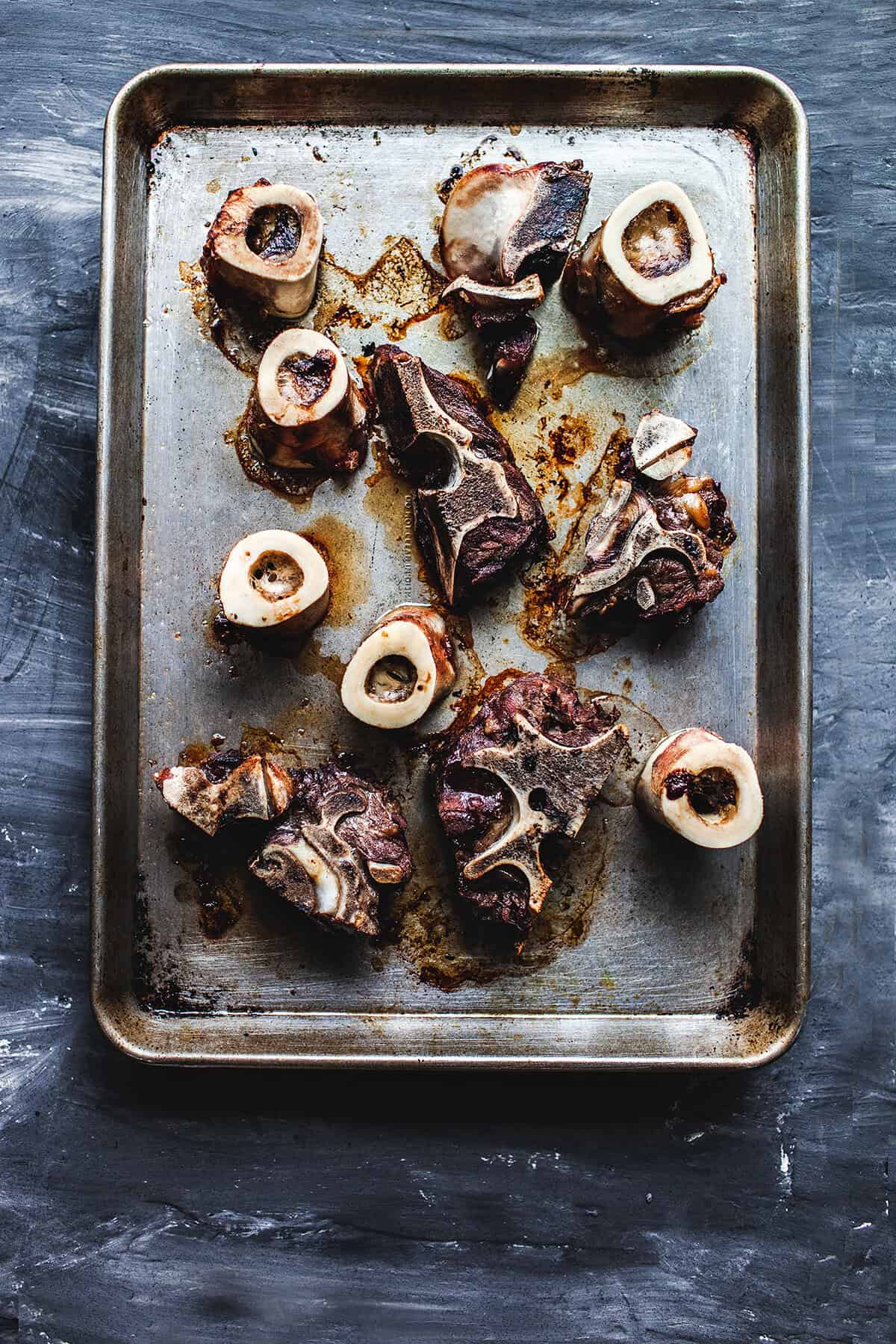 Beef bones on a baking pan.