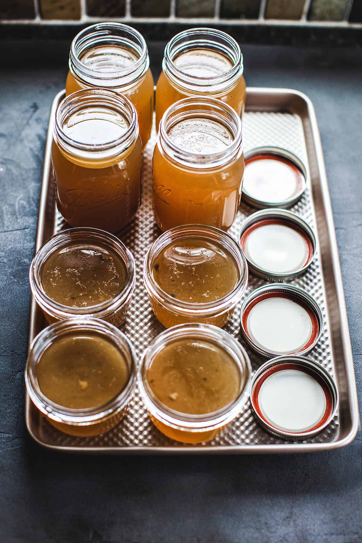 bone broth in mason glass jars on a tray.