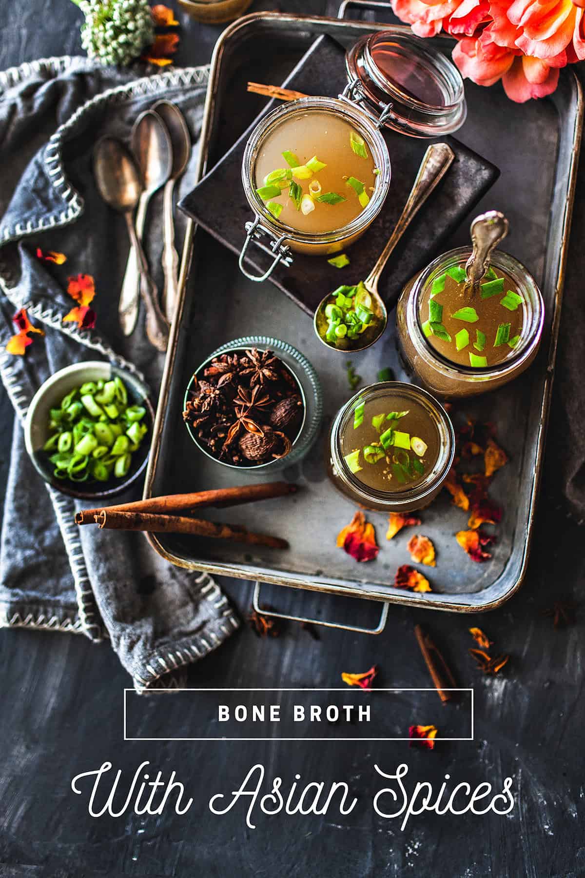 beef bone broth in glass jars on a tray.