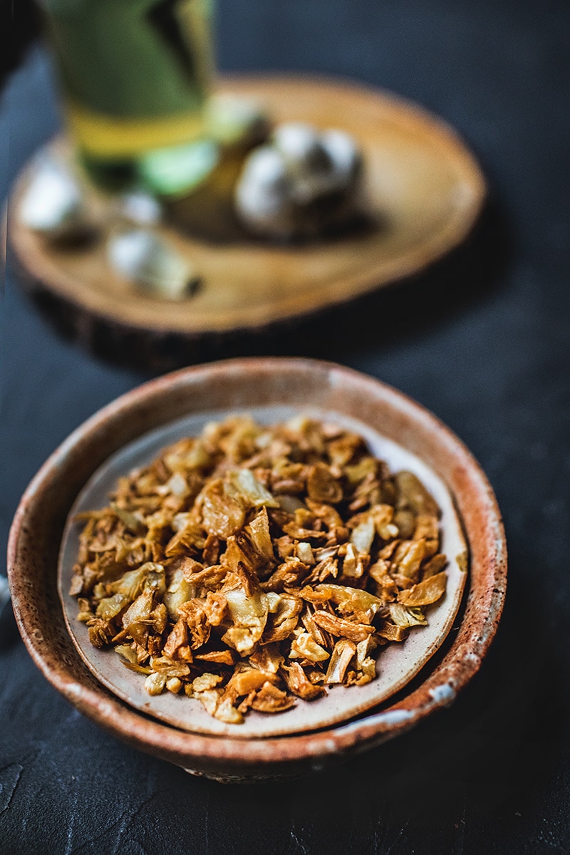 This Thai fried garlic recipe is a delicious topping used in many Thai dishes. The step by step, in photos, will show you how easy it is to make this aromatic crispy garnish! #thaifriedgarlic #crispyfriedgarlic #friedgarlicrecipe