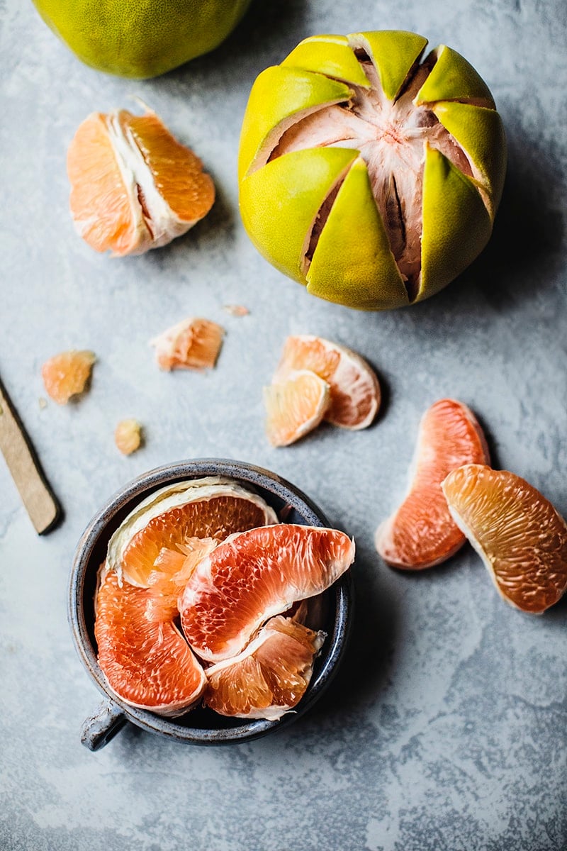 Peeled and sliced pomelos on a table 