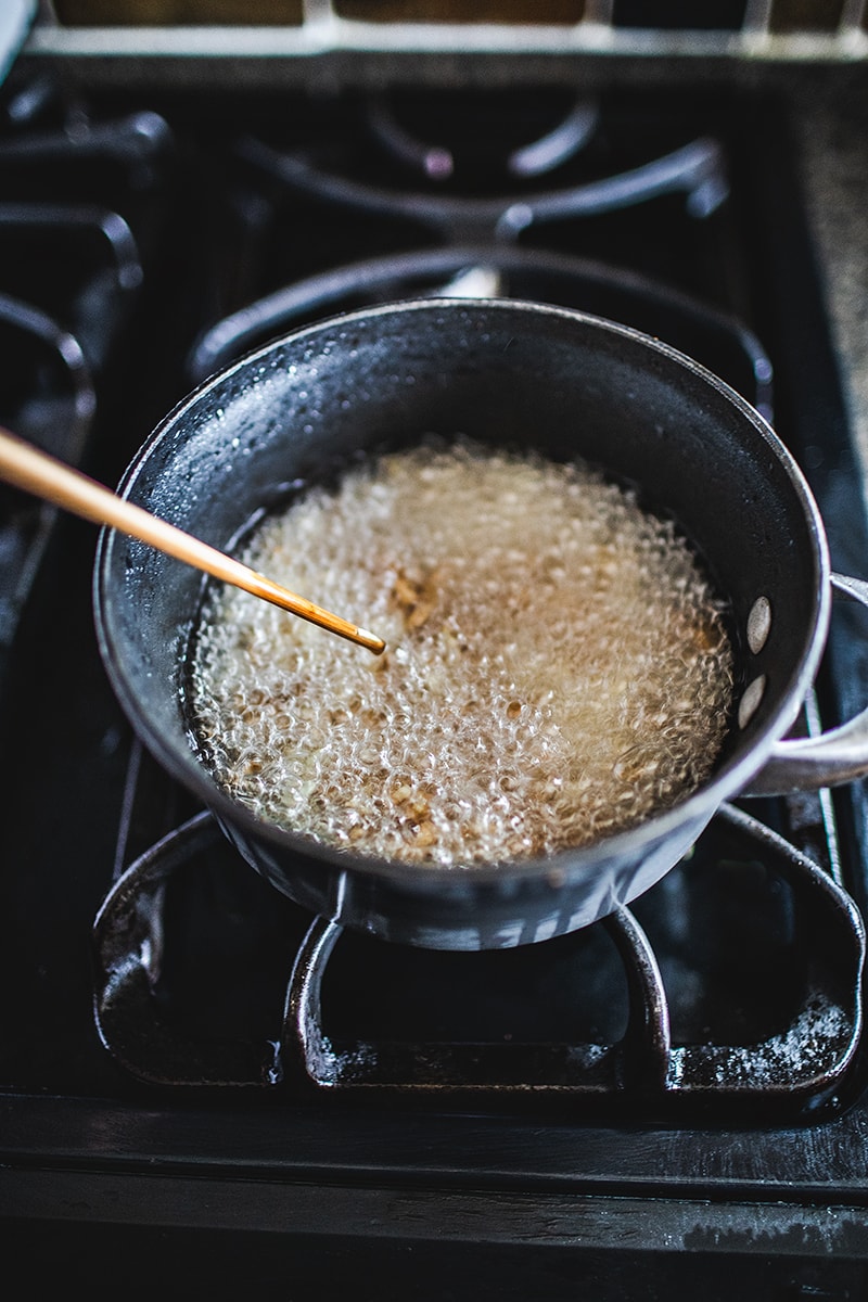 This Thai fried garlic recipe is a delicious topping used in many Thai dishes. The step by step, in photos, will show you how easy it is to make this aromatic crispy garnish! #thaifriedgarlic #crispyfriedgarlic #friedgarlicrecipe