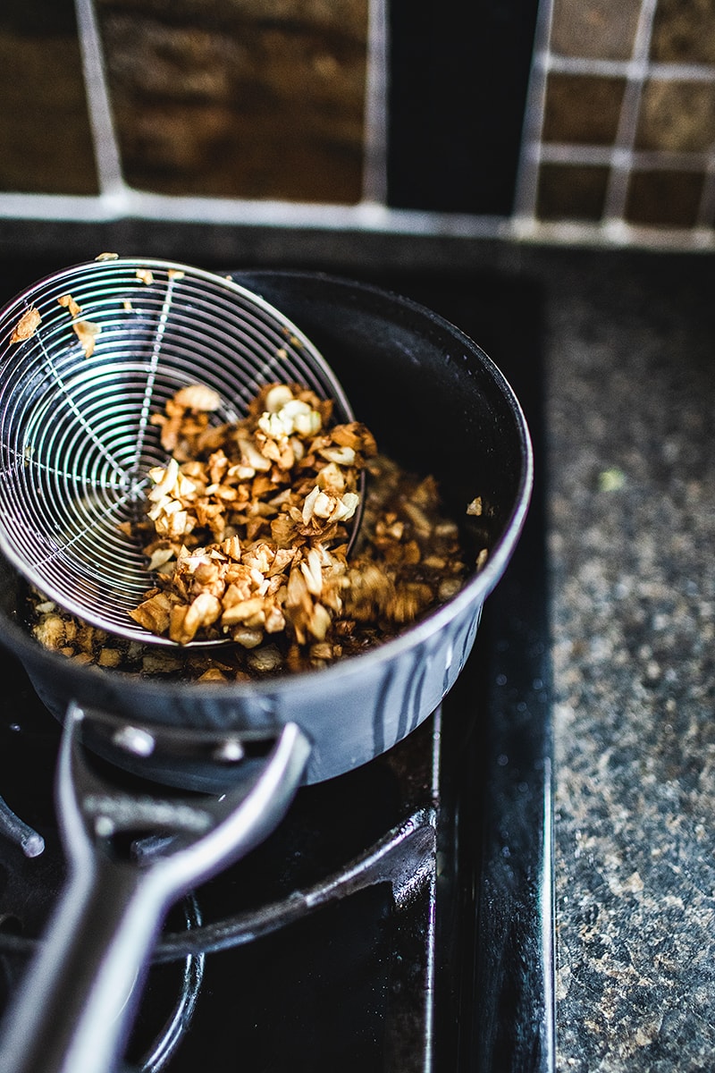 This Thai fried garlic recipe is a delicious topping used in many Thai dishes. The step by step, in photos, will show you how easy it is to make this aromatic crispy garnish! #thaifriedgarlic #crispyfriedgarlic #friedgarlicrecipe