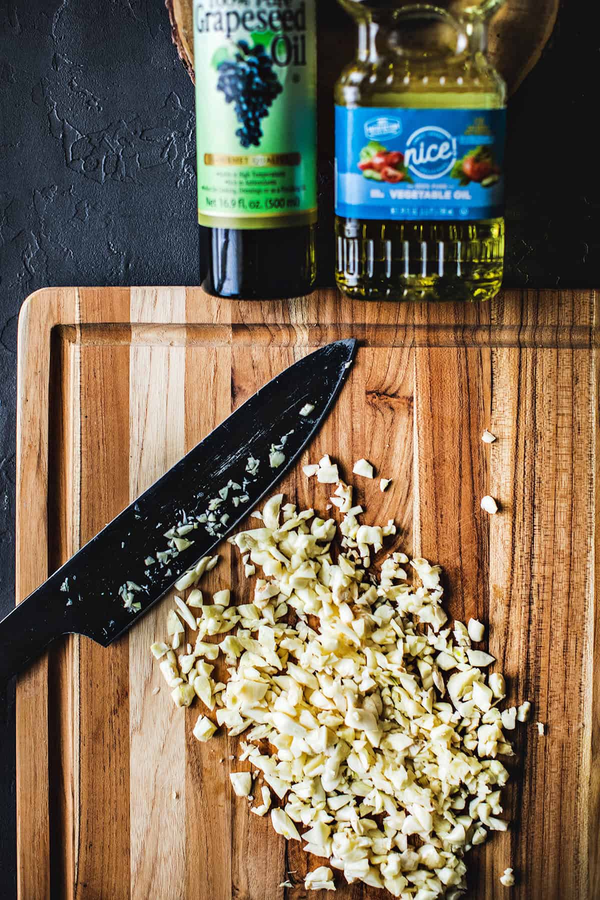 chopped garlic cloves on a cutting board. 