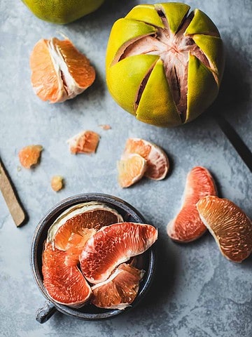 Pomelo fruits on a table.