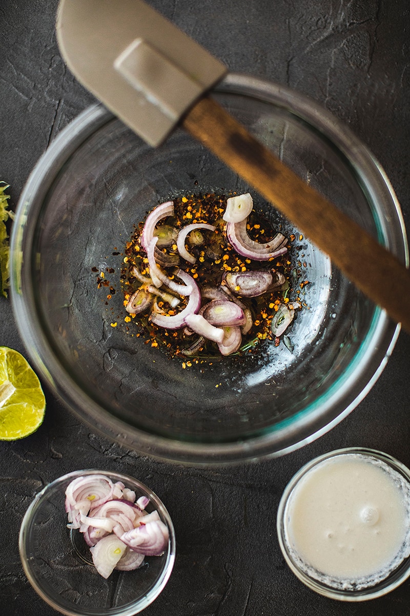 Thai pomelo salad dressing in a glass bowl on a table