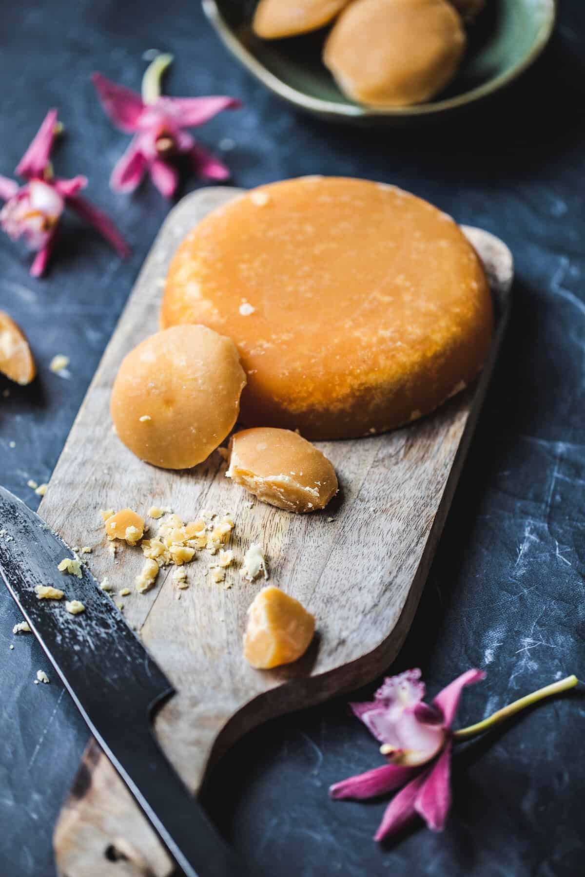 Palm sugar on a cutting board.