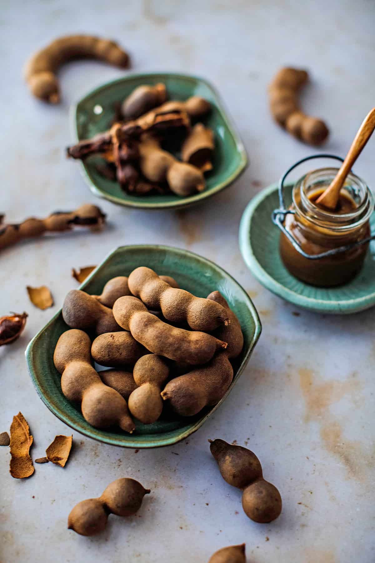 Tamarind pods in a green bowl.