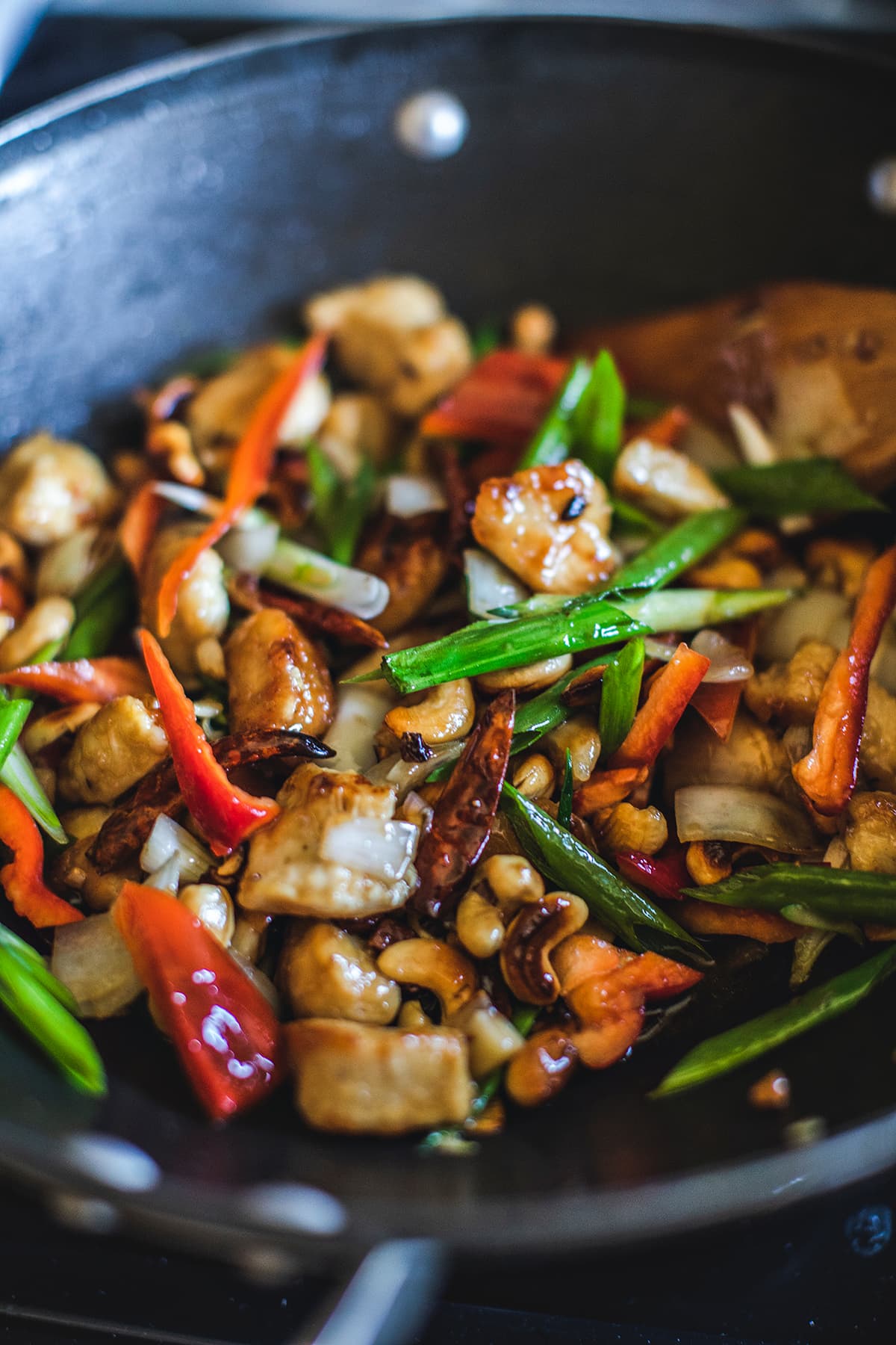 Cashew chicken stirs fry in a wok.