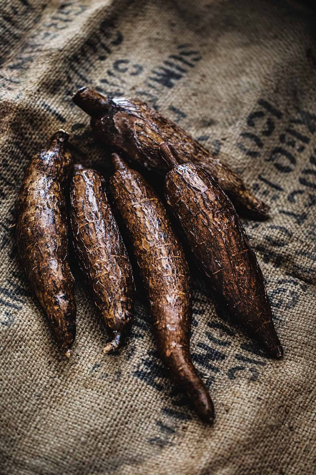 4 Cassava roots on a brown sack.