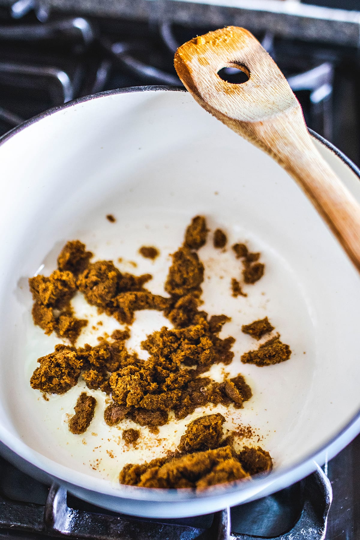 yellow curry paste in a soup stock on the stove