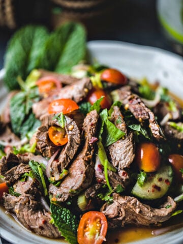 Thai beef salad on a plate.