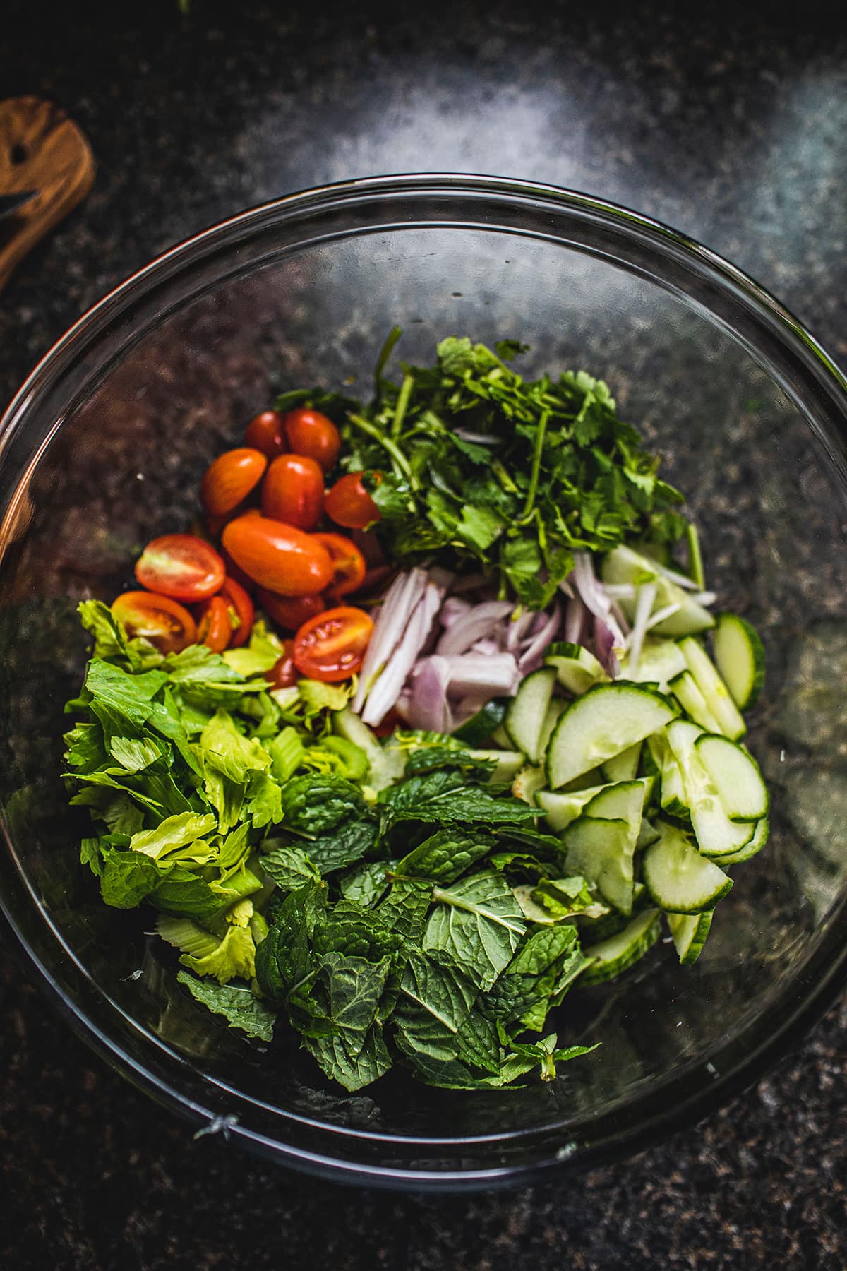 Thai beef salad vegetables in a glass bowl.