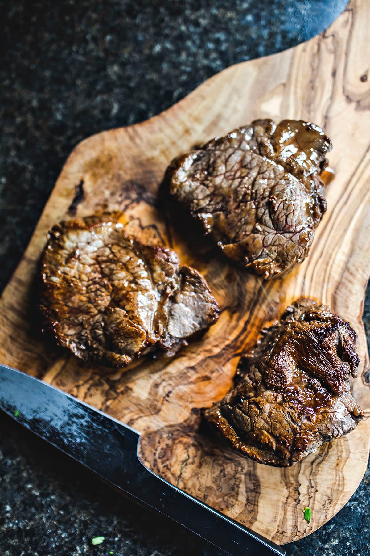 Cooked steak on a cutting board. 