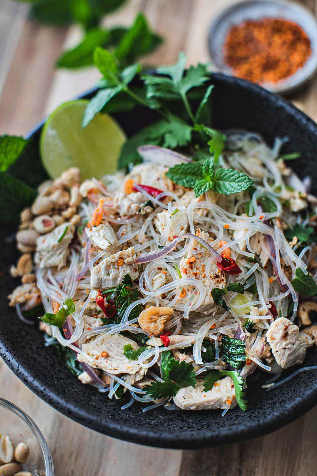 Thai glass noodle salad in a black bowl.